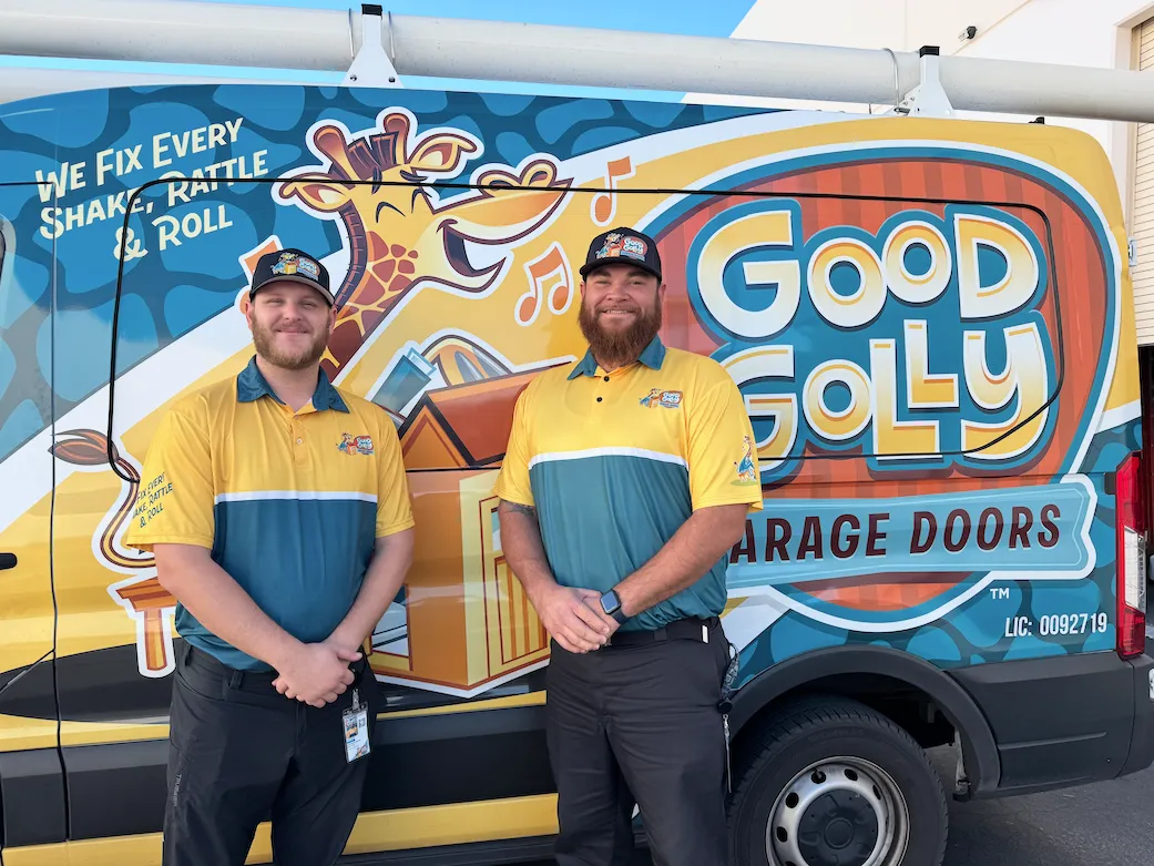 Good Golly Garage Doors technicians standing in front of a branded service vehicle